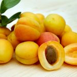 yellow round fruits on white table