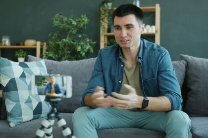 Man talking to a smartphone camera on a tripod